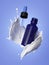 3d glass cosmetic bottle with dropper levitate inside white liquid splash isolated on lavender background. Aroma oil, serum