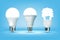 3D glowing CFL and LED light bulbs on blue background, realistic style. Idea, creativity and innovation concept