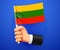 3d hand holding Lithuania National flag.