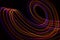 3d illustration. Abstract lines of light painting of reddish colors on black background