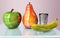 3d illustration of apple banana in glass and pear creative still life on glass table in pink room with day light imitation