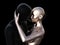 3d illustration. Bald couple hugging. Black man and silver woman on a black background.