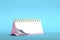 3d illustration of blank pink desk paper calendar on a minimal blue pastel colored background