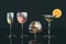 3d illustration of cognac, wine, red wine, martini glasse lemon slice in row on dark background