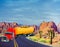 3D Illustration of colorful tanker truck traveling across desert highway
