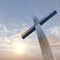 3D illustration conceptual wood cross or religion symbol shape over a sunset sky with clouds background