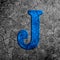 3d illustration cracked blue stone wall letter J on black grunge cement surface