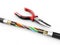 3d Illustration of Electric cable with pliers. Copper electrical cable in multi-colored insulation on a white background