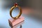 3D illustration of a gold ring with a big red diamond on a pink stand