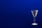 3D illustration of liqueur or vermouth glass on blue - mockup with place for your text - drinking glass render