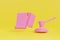 3d illustration of a pink judge\\\'s hammer on a yellow background