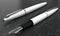 3d illustration render of white fountain pens mockup on black marble background