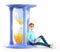 3D illustration of smiling man working on his laptop and sitting on a huge hourglass. Cute cartoon businessman