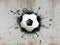 3d illustration of a soccer ball stuck in a concrete wall