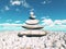 3D landscape with balancing zen pebbles with sunny blue sky