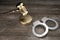 3D law, crime concept - handcuffs, golden gavel