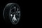 3D model of a Car wheel, a disc of a metallic color, a car wheel on a black background. Tire service, car service, repair,