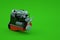 3d model of a mechanical part of a red large piston on a green isolated background. Mechanical part, repair, repair. Red
