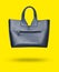 3D photo fashionable leather handbag isolated on yellow background. Minimalism