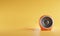 3D portable orange color sphere audio speaker isolated on yellow background with clipping path. Minimalism concept. 3d rendering