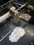 3D printer in action, printing of a complex white buliding model in progress, new technology, closeup