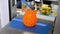 3D printer prints the figure orange