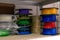 3D printing material, ABS filament, PLA & x28;Polylactic Acid& x29;,  PVA Filament.  Colored polymer in coils on the shelves