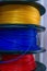 3D printing material, ABS filament, PLA & x28;Polylactic Acid& x29;,  PVA Filament.  Colored polymer in coils on the shelves