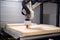 3d printing robot depositing layer of material onto 3d printing bed