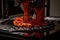 3d printing robot extruding layer of molten plastic to create intricate design