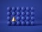 3d render, abstract geometric design: gold cone amongst blue balls isolated on blue background. Balance, gravity