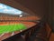 3D render of beautiful modern round rugby stadium with orange seats and VIP boxes