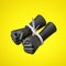 3d render, black human hands fists tied with plastic zip ties, isolated on yellow background.