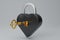 3D render black metal heart-shaped Padlock icon with gold key isolated on white background. Minimal black lock with a golden key.