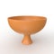 3D render of a bright orange bowl on a pristine white background