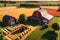 3D Render: Bustling Farm Life with Textured Hay Bales Dotting Golden Fields, Rustic Red Barn, and Farmland Scenery