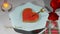 3D render of a cake in the form of a stylized heart on a plate in a romantic setting on February 14 with an animated candle with t