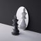 3d render, chess game king piece stands in front of the round mirror. Perceptual distortion concept. Mental disorder condition.