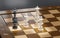 3d render chessboard with two pawns checkmate on black background