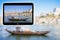 3D render concept image with a digital tablet showing a typical portuguese wooden boats, called Barcos Rabelos, used in the past