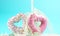 3d render of couple of heart-shaped donuts on blue background and spilled milk. Valentine`s concept.