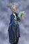 3D render of a fairy godmother or witch fantasy style character holding a wand and spell book