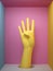 3d render, female yellow artificial hand four fingers up, mannequin body part isolated on pink background inside square box