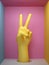 3d render, female yellow artificial hand victory sign, mannequin body part isolated on pink background inside square box