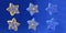 3d render. Festive blue and gold star shaped ornaments isolated on blue background. Christmas clip art set
