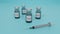 3d render of glass covid-19 vaccine vials and a plastic syringe