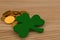 3d render of golden coins on the table wooden, close to a shamrock. Celebration of Saint Patrick& x27;s Day.