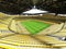 3D render of a large capacity soccer - football Stadium with an open roof and yellow seats