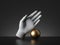 3d render, mannequin hand and golden ball, palmistry metaphor, isolated on black background, modern minimal concept.