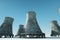 3D render Nuclear power plant against the background of nature, cooling tower towers nuclear fusion clean energy. Copy space